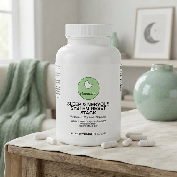 A bottle of magnesium glycinate supplement sits on a cream linen surface in a serene, sage-toned bedroom setting.
